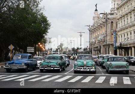 Old cars used as taxis on the Prado (Paseo de Marti), Alicia Alonso Grand Theater of Havana in background, Havana, Cuba Stock Photo