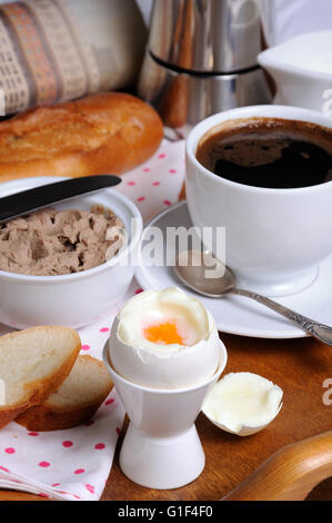 Eggs boiled in pashotnitse for breakfast with a cup of coffee and liver pate Stock Photo