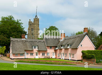 Almshouses - and the tower of St Mary's Church - in the village of Cavendish, Suffolk, England UK Stock Photo