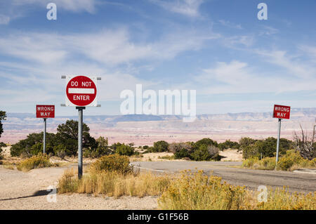 wrong way and do not enter signs along a road in the desert southwest Stock Photo