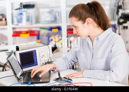 MODEL RELEASED. Female electrical engineer using laptop. Stock Photo