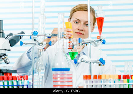 MODEL RELEASED. Female chemist working in laboratory. Stock Photo