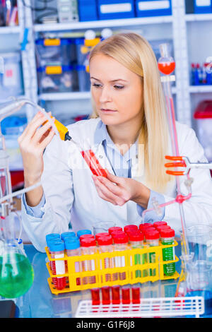 MODEL RELEASED. Female chemist working in the laboratory. Stock Photo