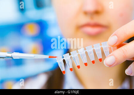 MODEL RELEASED. Female scientist holding micro test tubes and pipette. Stock Photo