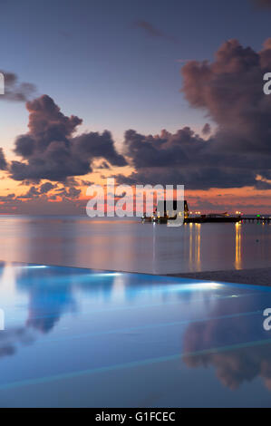 Infinity pool at Olhuveli Beach and Spa Resort at sunset, South Male Atoll, Kaafu Atoll, Maldives