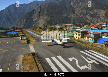 Take off from the short runway at Lukla Airport near mt Everest Stock Photo