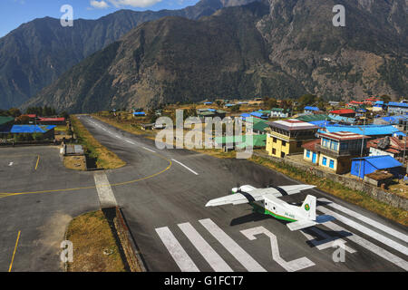 Take off from the short runway at Lukla Airport near mt Everest Stock Photo