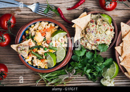 Homemade mexican salad scrambled egg served with corn tortilla chips and guacamole, healthy breakfast,  mexican food Stock Photo