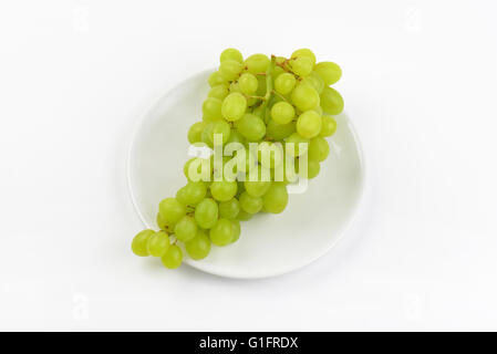 bunch of white grapes on white plate Stock Photo