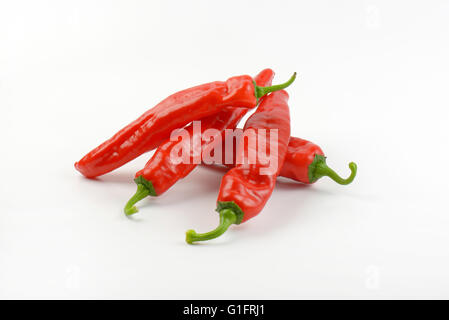 four red peppers on white background Stock Photo