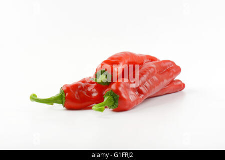 four red peppers on white background Stock Photo