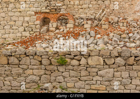 beautiful dry stone walls with remnants of brick arches Stock Photo
