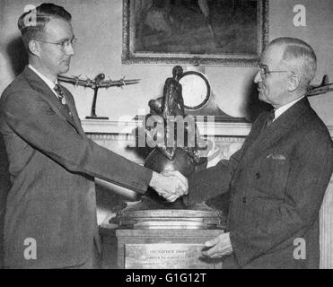 LUIS WALTER ALVAREZ (1911-1988) American physicist at left receives the Collier Trophy from US President Harry Truman at the White House in 1946. Awarded by the US National Aeronautic Association in recognition of his work on Ground Control Approach systems for aircraft. Stock Photo