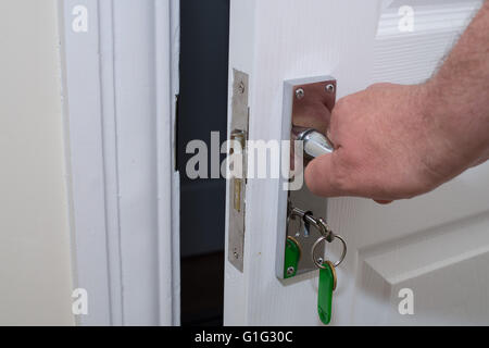 Mans hand opening a door Stock Photo
