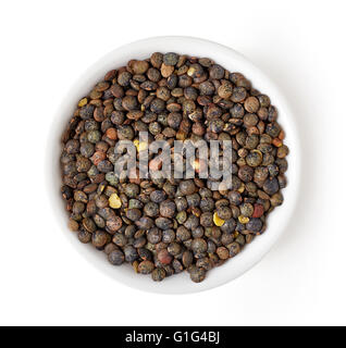 Bowl of dry green lentil isolated on white background, top view Stock Photo