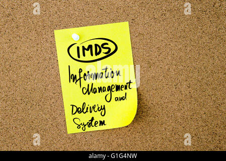 Business Acronym IMDS Information Management and Delivery System written on yellow paper note pinned on cork board with white thumbtack, copy space available Stock Photo