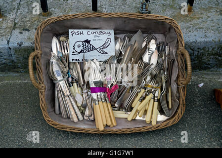 A basket of fish cutlery outside an antique shop in Edinburgh's New Town. Stock Photo