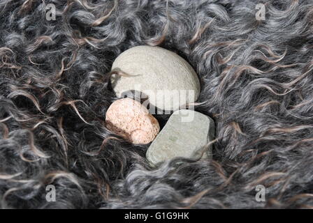 Hard stone in soft wool Stock Photo