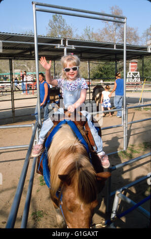 3 years old girl riding pony in Irvine Regional Park.© Myrleen Pearson