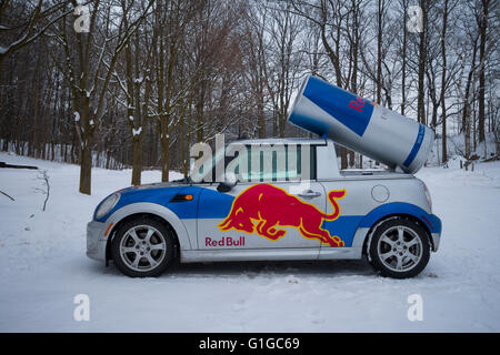 A Red Bull Mini car parked in a snow covered parking lot in Hamilton, Ontario, Canada. Stock Photo