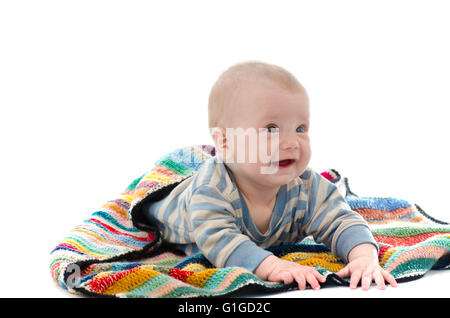 Sweet baby boy on colorful blanket crying isolated on white Stock Photo