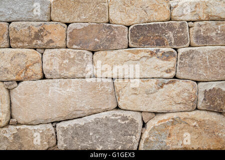 Close-up of an old stone wall texture background. Stock Photo
