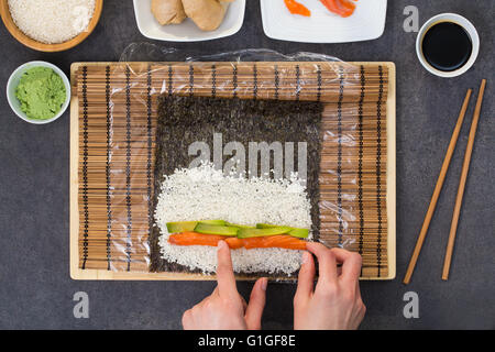 sushi roll process of making raw makki fresh seafood susi - stock image Stock Photo