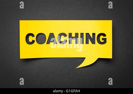 Bubble speech with cut out phrase 'coaching' in the paper.