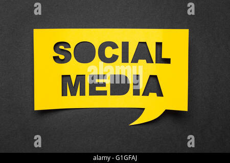 Bubble speech with cut out phrase "social media" in the paper. Stock Photo