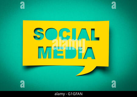 Bubble speech with cut out phrase "social media" in the paper. Stock Photo
