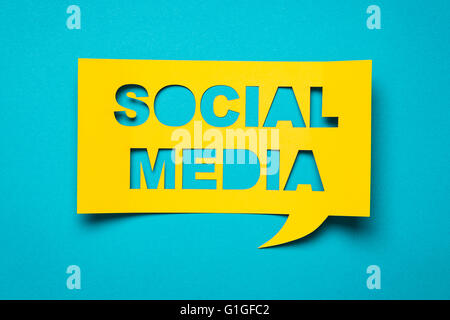 Bubble speech with cut out phrase "social media" in the paper. Stock Photo