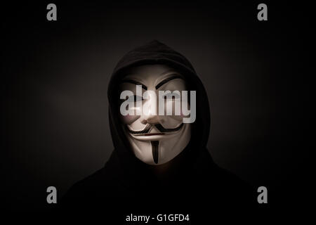 Bełchatow, Poland - December 06, 2015: Man wearing Vendetta mask - symbol for the online hacktivist group Anonymous. Stock Photo