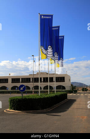 Company flags with logo Bibendum figure flying outside, Michelin factory and research establishment, Almeria, Spain Stock Photo