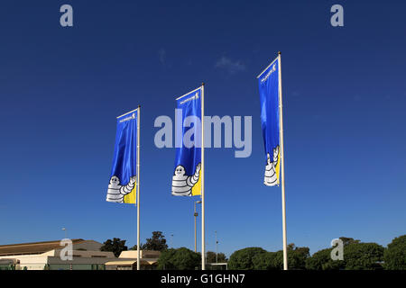 Company flags with logo Bibendum figure flying outside, Michelin factory and research establishment, Almeria, Spain Stock Photo