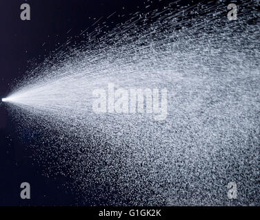 Water jet spraying on black background Stock Photo