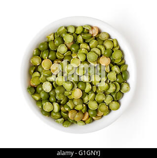 Bowl of green split peas isolated on white background, top view Stock Photo
