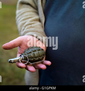 Male hand holding grenade Stock Photo