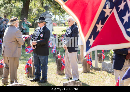 Charleston, USA. 14th May, 2016. Members of the Sons of the Confederacy during a flag raising ceremony during a memorial service at Magnolia Cemetery to mark Confederate Memorial Day May 14, 2016 in Charleston, South Carolina. The events marking southern Confederate heritage come nearly a year after the removal of the confederate flag from the capitol following the murder of nine people at the historic black Mother Emanuel AME Church. Credit:  Planetpix/Alamy Live News Stock Photo