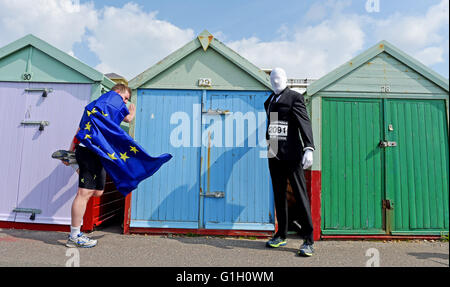 Hove Brighton UK 15th May 2016 - Runners warm up before taking  part in the Heroes v Villains Save the Day charity run along Hove seafront today raising money for Pass It On Africa  Credit:  Simon Dack/Alamy Live News Stock Photo