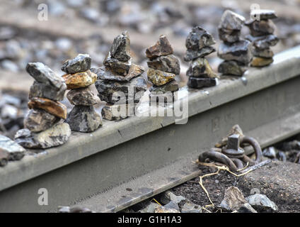 Environmental activists have placed small piles of stones on the train tracks at the loading station for brown coal near the Welzow Sued strip mine of Vattenfall AG in Welzow, Germany, 15 May 2016. Here brown coal is loaded from the conveyor belt onto trains. The protests from the protest alliance 'Ende Gelaende' are part of a worldwide campaign directed against the use of fossil fuels like coal and oil. Photo: PATRICK PLEUL/dpa Stock Photo