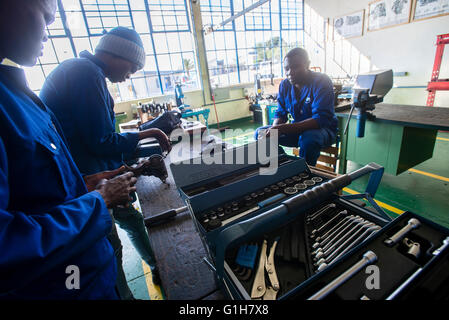 Students of the Automechanical course assemble starter motor during their practical lesson at workshop in the Windhoek Vocational Training Centre, Namibia Stock Photo