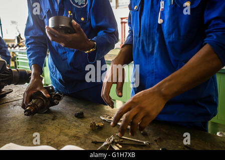 Students of the Automechanical course assemble starter motor during their practical lesson at workshop in the Windhoek Vocational Training Centre, Namibia Stock Photo