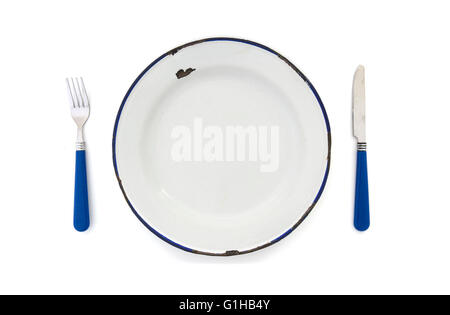 Overhead View of an old enamel plate with blue knife and fork on a white background Stock Photo