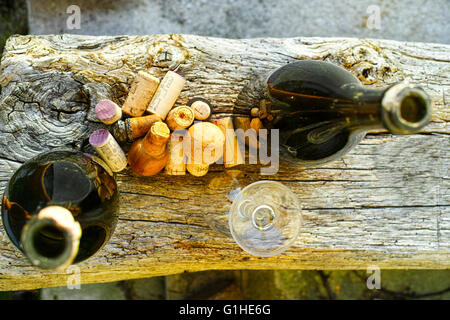 Old used vine corks on wooden textured background in the garden Normandy France Stock Photo