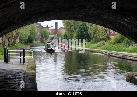 Two narrowboats pass each other on the canal at St Vincent Street Bridge in Birmingham, England Stock Photo