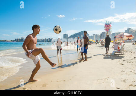RIO DE JANEIRO - FEBRUARY 27, 2016: Young Brazilians play a game of altinho beach football on the shore of Copacabana Beach.