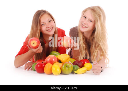 Two girls holding fresh fruits isolated on white Stock Photo