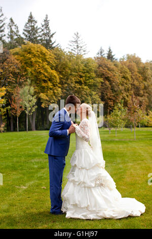 The groom kisses the bride tenderly Stock Photo