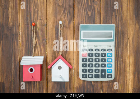 model house with Calculator on wooden background Stock Photo