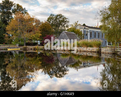 Dexter Grist Mill, Sandwich MA Cape Cod Massachusetts USA seen across the millpond in autumn fall colors colours reflections in the pond Stock Photo